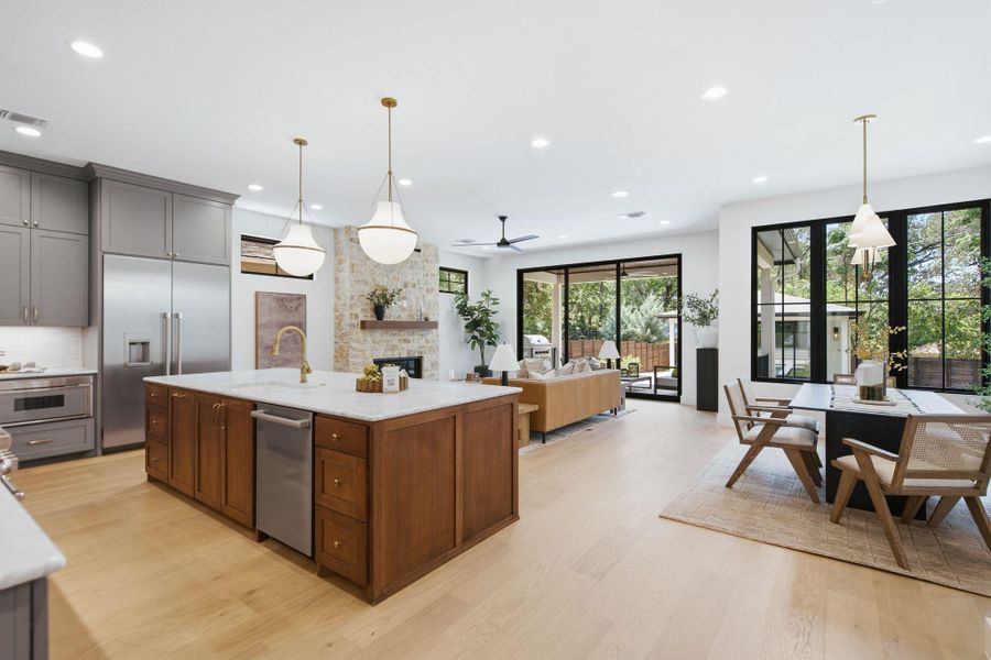 An open floor plan seamlessly connects the kitchen and dining area to the backyard.