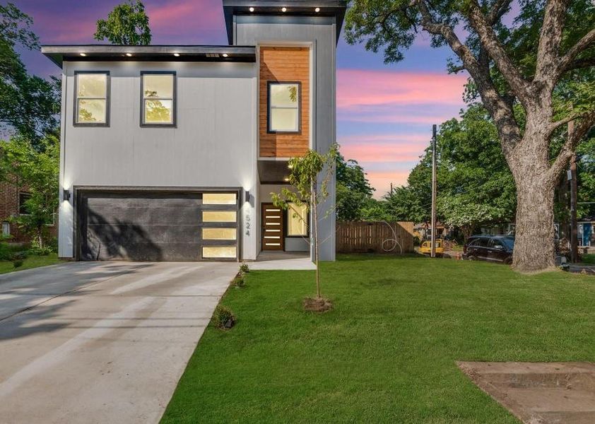 Contemporary house featuring a garage and a lawn