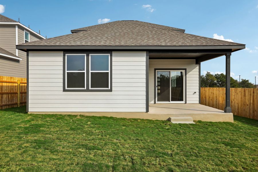 A house with a fence and grass.
