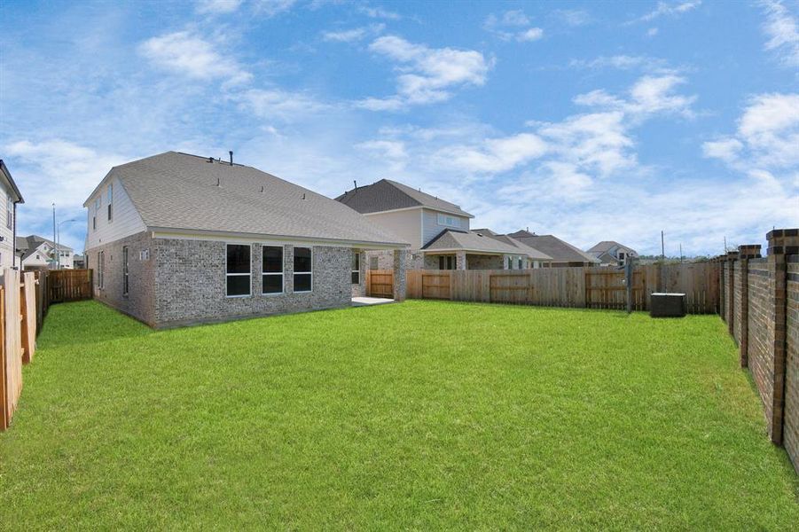 Spacious backyard with its beautiful covered patio. There is plenty of room for the kids to play and adults to relax. Perfect for your outdoor living space, patio furniture, bbq pit, and so much more. The possibilities are endless!