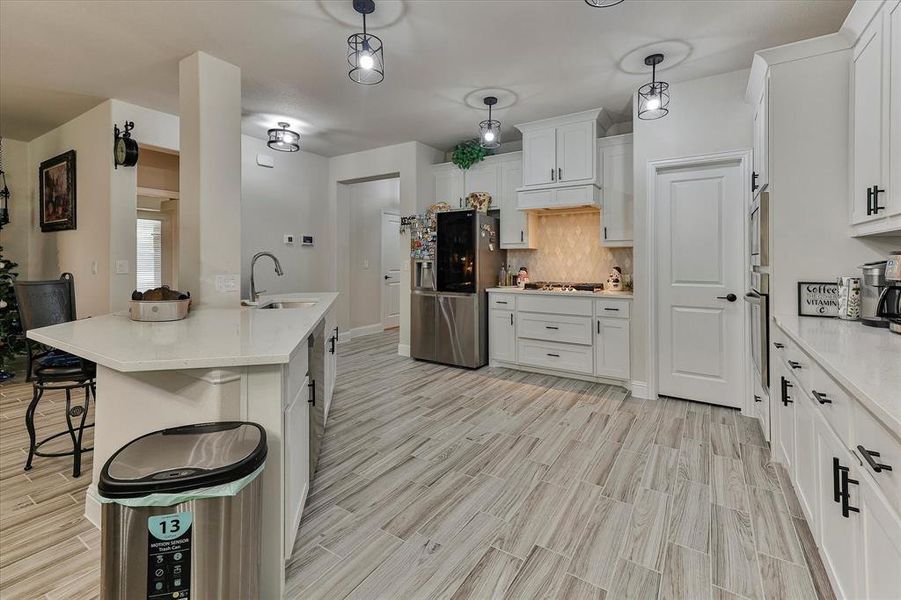 Gourmet kitchen is a chef's dream featuring gas cooktop, built in oven and microwave, upgraded hardware, sleek stainless steel appliances, island seating and walk in pantry Gourmet kitchen is a chef's dream featuring gas cooktop, built in oven and microwave, upgraded hardware, sleek stainless steel appliances, island seating and walk in pantry