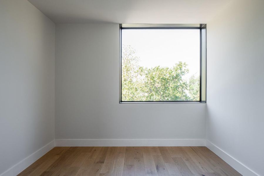 Empty room featuring light wood-style flooring and baseboards