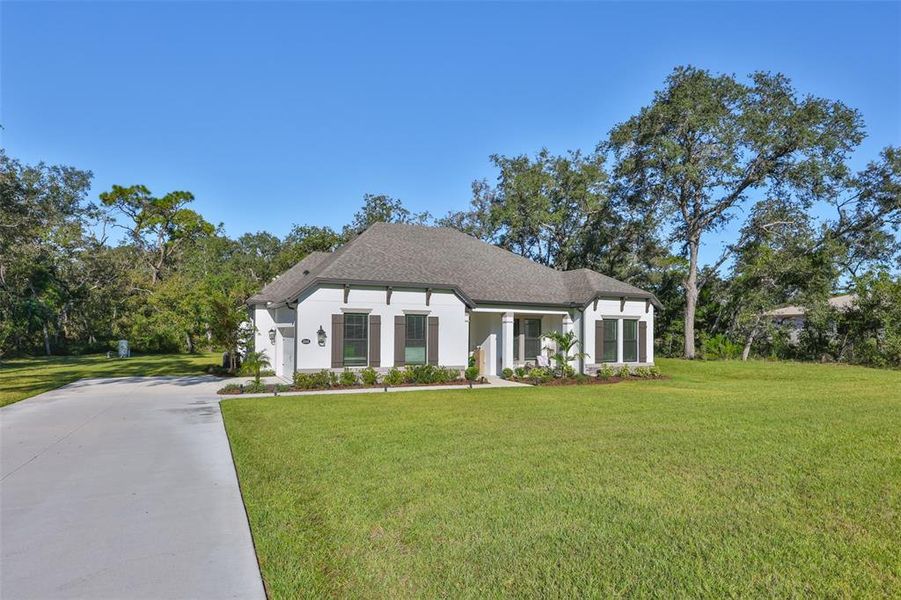 Front exterior of a new home in Bella Terra, Hudson, FL, highlighting curb appeal (Image 20).