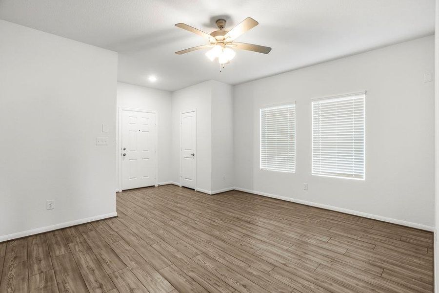Unfurnished room featuring wood finished floors and ceiling fan