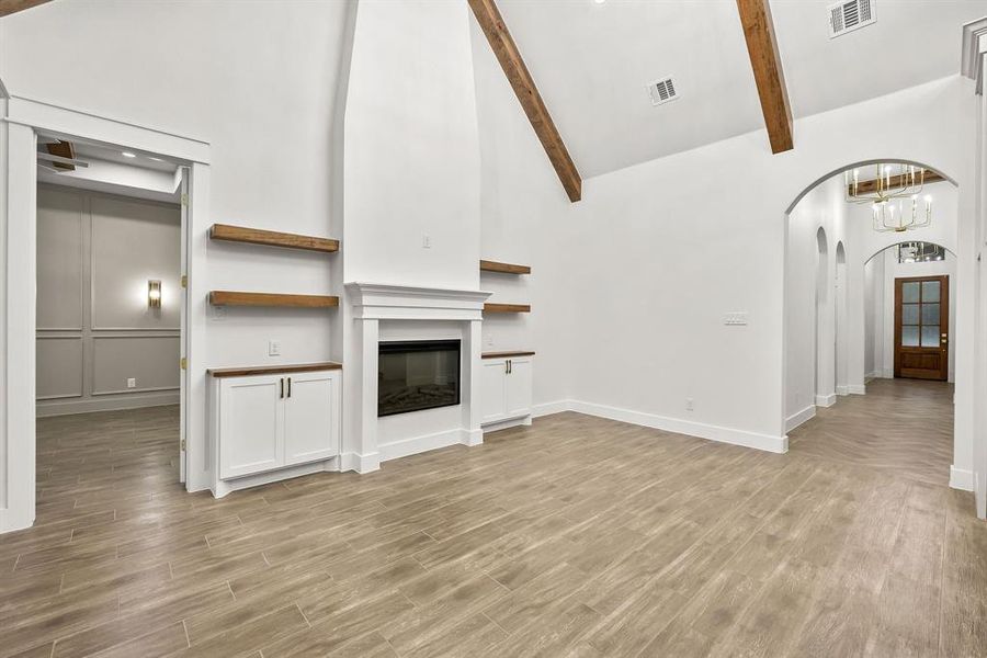 Vaulted ceiling featuring exposed wood beams