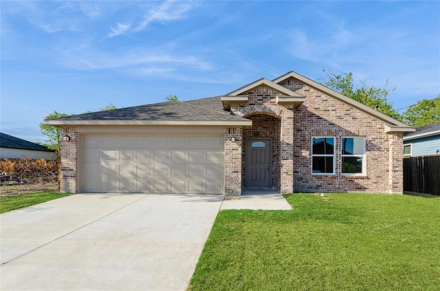 View of front facade with a garage and a front lawn