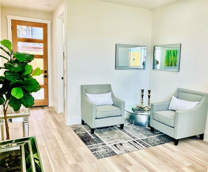 Chic entry way retreat with stylish reading corner.