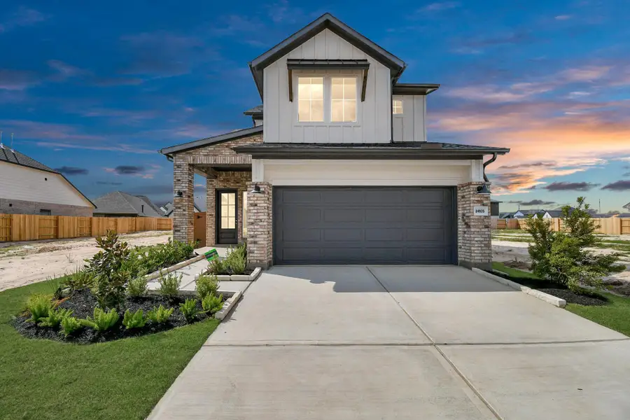 Front exterior of a new home in Elyson, Katy, TX, highlighting curb appeal (Image 2).