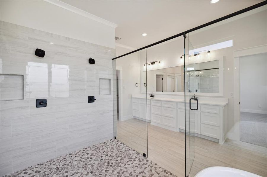 Bathroom featuring vanity and separate shower and tub