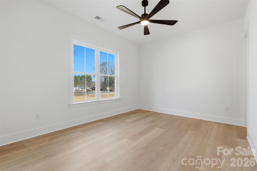 bedroom 2- front bedroom w/ ensuite bath, wood shelves