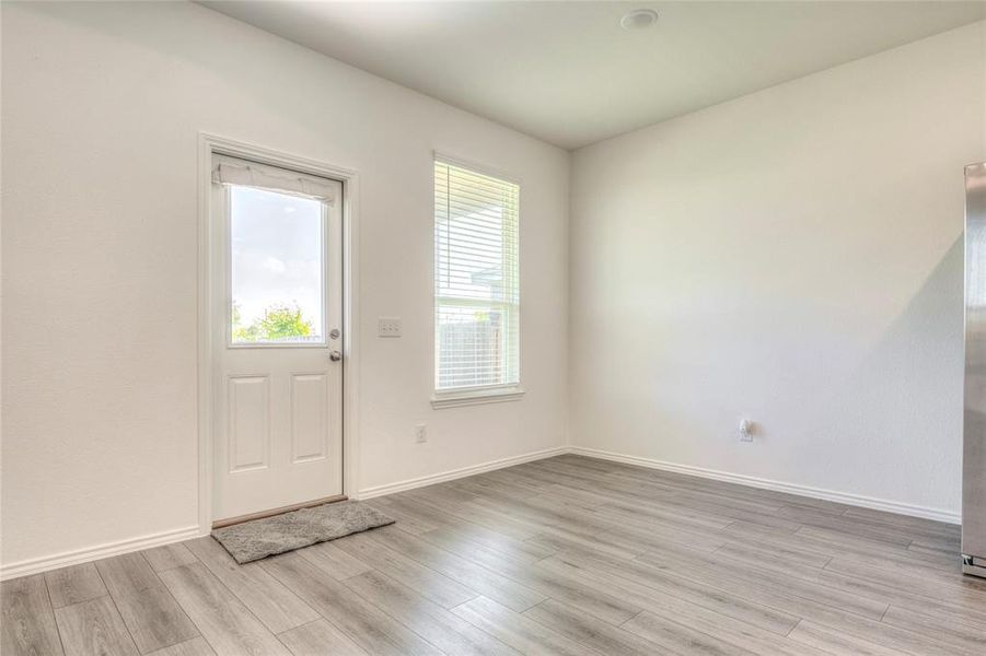 Entrance foyer featuring baseboards and light wood-style flooring Entrance foyer featuring baseboards and light wood-style flooring