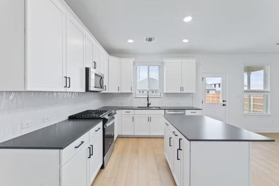 Photo of Pulte model home with same floor plan, not of actual home listed.