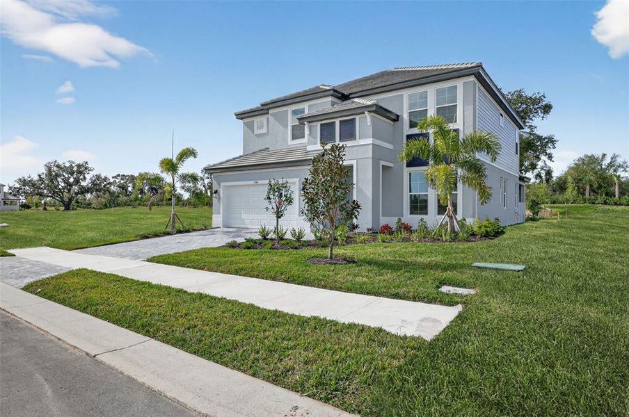 Front exterior of a new home in Hawkstone, Sarasota, FL, highlighting curb appeal (Image 21).