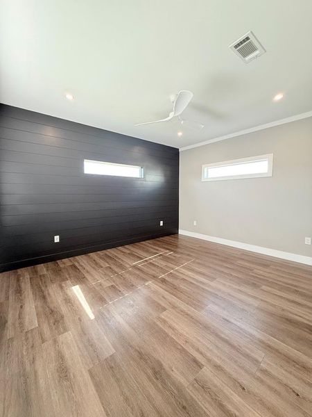 Clean lines and wood-look flooring define this inviting, naturally lit room.