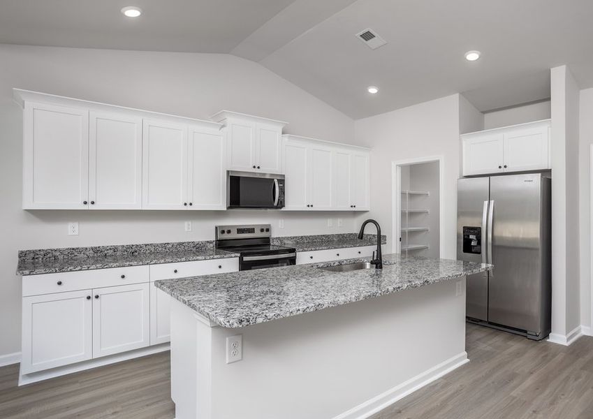 The kitchen has designer wood cabinetry