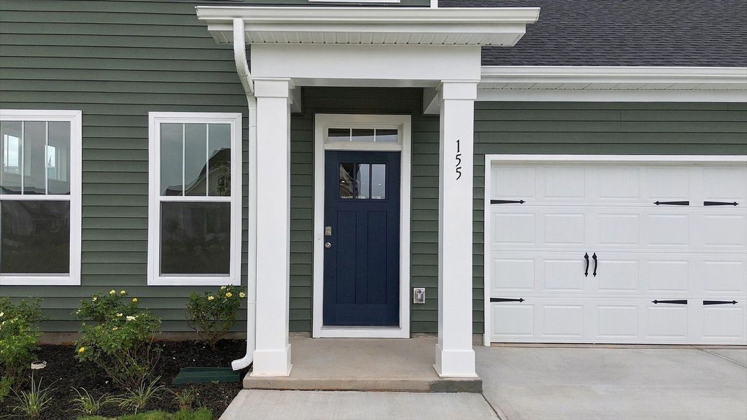 Warm and welcoming exterior enhanced by polished finishes and thoughtful design by DRB Homes