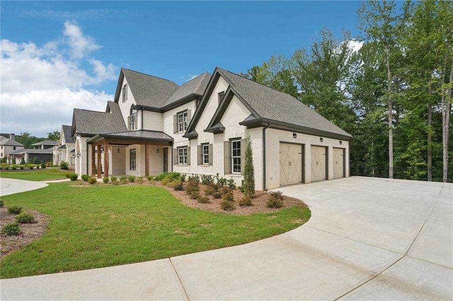Front exterior of a new home in The Reserve At Governors Towne Club, Acworth, GA, highlighting curb appeal (Image 2). Front exterior of a new home in The Reserve At Governors Towne Club, Acworth, GA, highlighting curb appeal (Image 2).