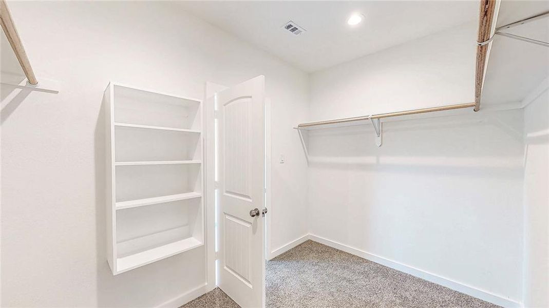 7x11- primary suite closet with built-in shelving