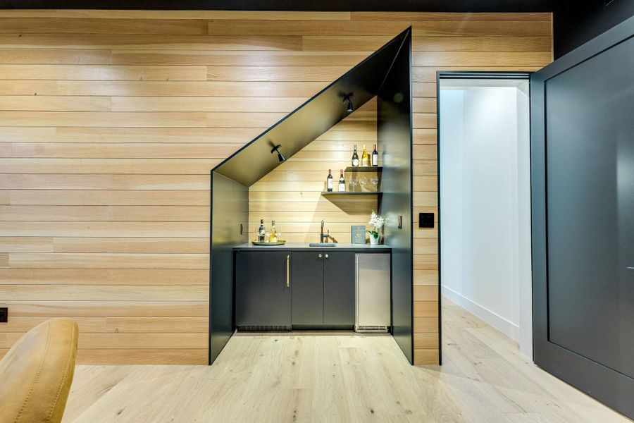 Custom bar area, complete with a wine fridge, offers an ideal space for entertaining. Custom bar area, complete with a wine fridge, offers an ideal space for entertaining.
