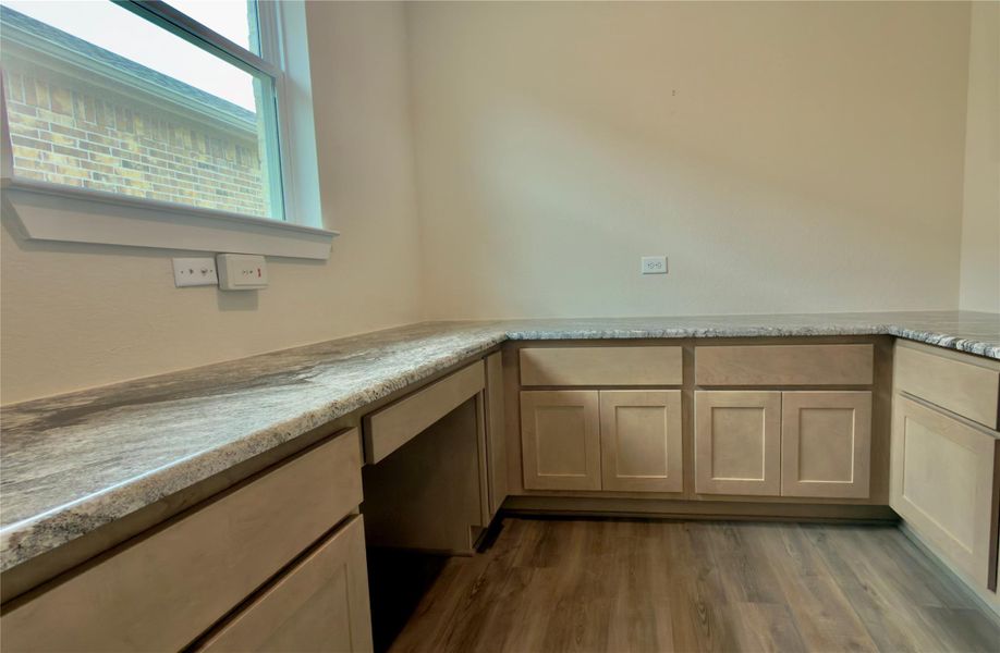 A view of the pocket office with granite counters and Kent Moore cabinets on 3 sides.