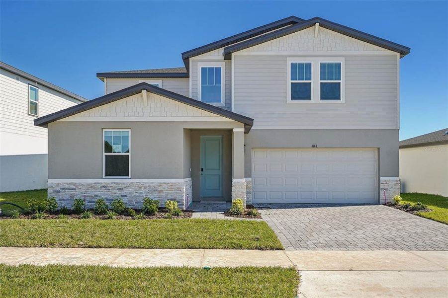 Front exterior of a new home in The Reserve at Hammock Oaks - Signature Series, Lady Lake, FL, highlighting curb appeal (Image 18).