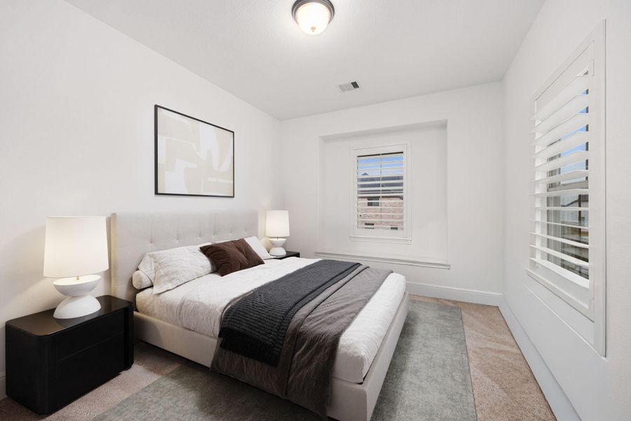 This secondary bedroom offers a bright layout with neutral finishes and natural light.