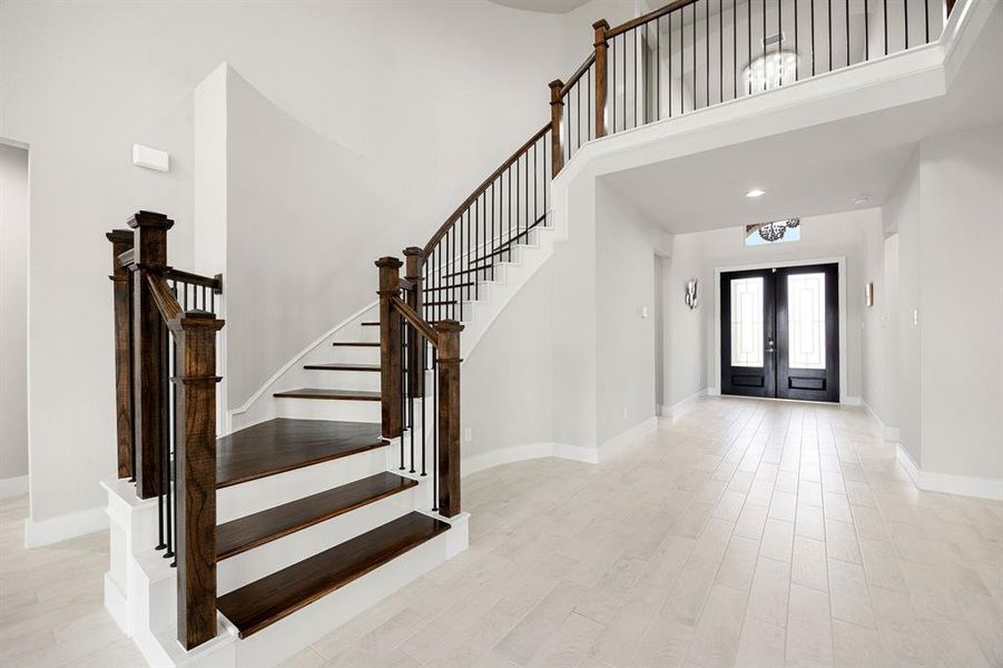 A beautifully upgraded, carpet-free staircase leadsto the upstairs