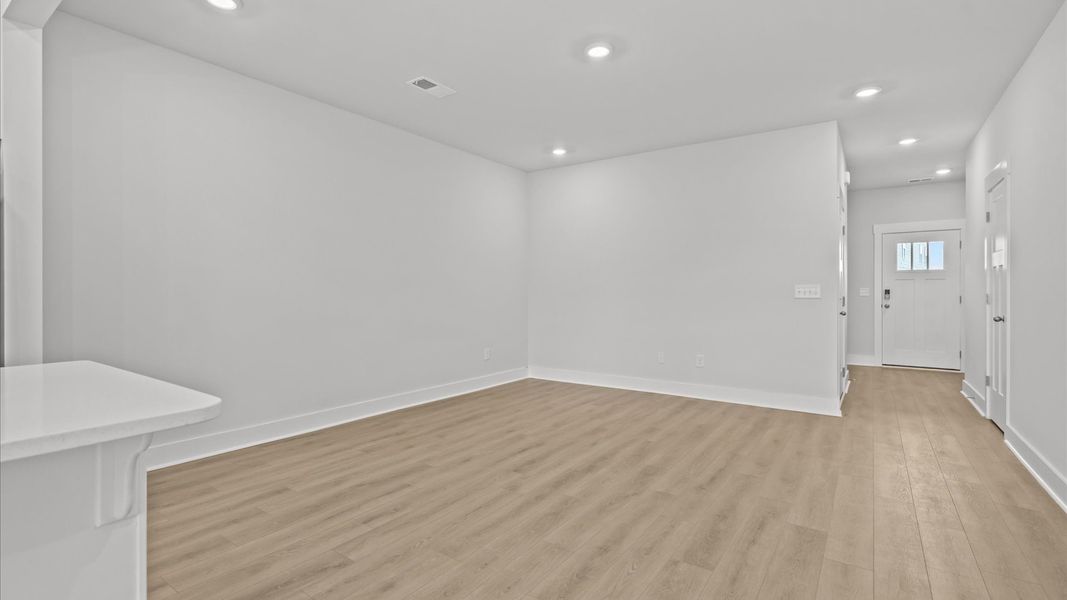 Vibrant and welcoming family room anchored by clean lines, tasteful materials, and abundant light