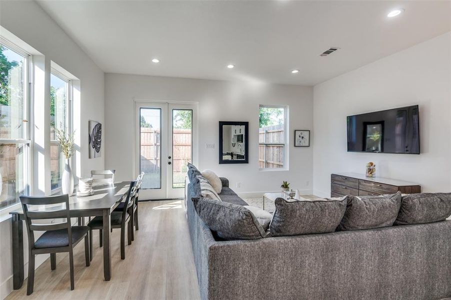 Living room with light hardwood / wood-style floors and french doors