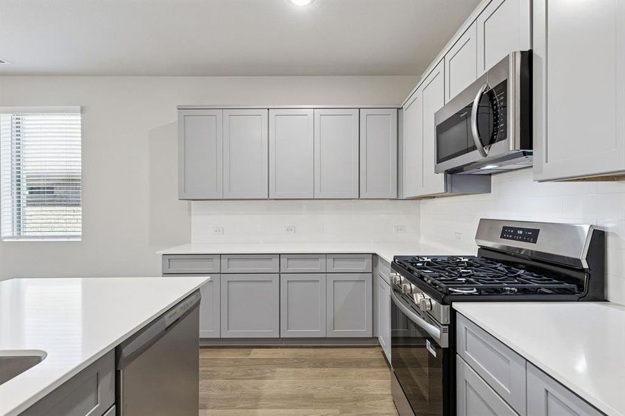 Kitchen in the Haylee home plan by Trophy Signature Homes - REPRESENTATIVE PHOTO