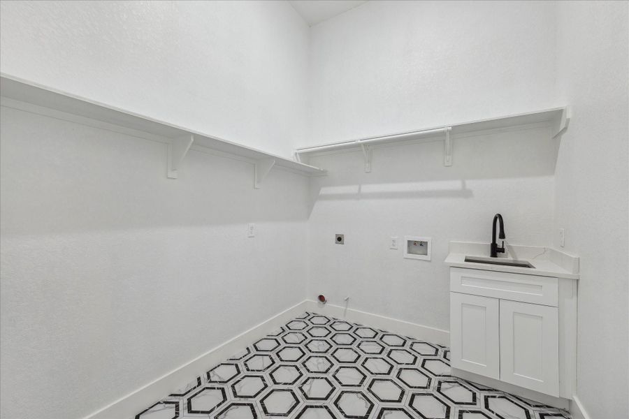 The Laundry Room has ample storage, Cabinet & Sink
