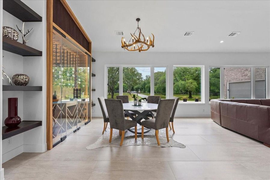 Expansive windows frame the private grounds, allowing natural light to pour into the room.