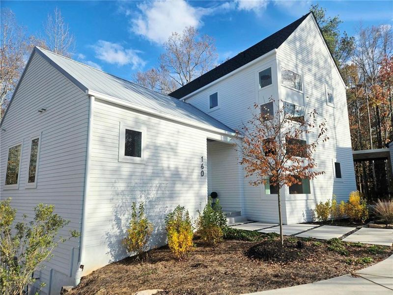 Front exterior of a new home in Aster, Roswell, GA, highlighting curb appeal (Image 23). Front exterior of a new home in Aster, Roswell, GA, highlighting curb appeal (Image 23).