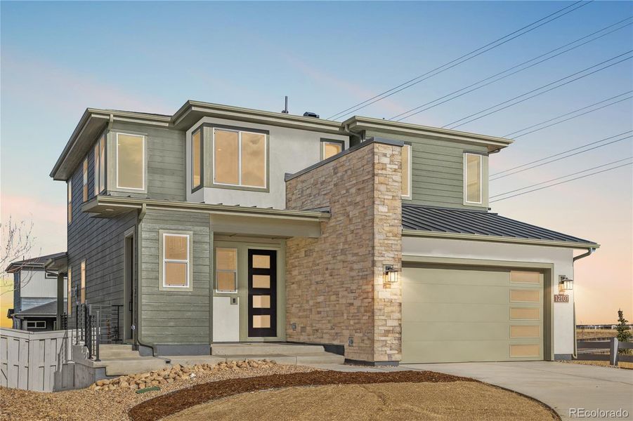 Front exterior of a new home in Tribute at Lyric, Lone Tree, CO, highlighting curb appeal (Image 2). Front exterior of a new home in Tribute at Lyric, Lone Tree, CO, highlighting curb appeal (Image 2).
