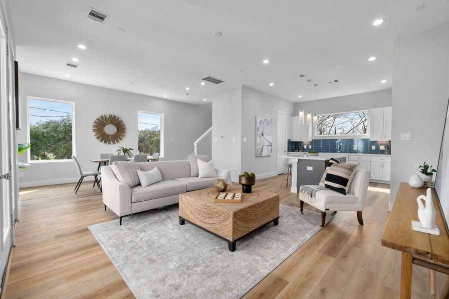 Spacious open-concept living area with abundant natural light, high ceilings, and seamless flow into the kitchen and dining spaces, ideal for everyday living and entertaining.