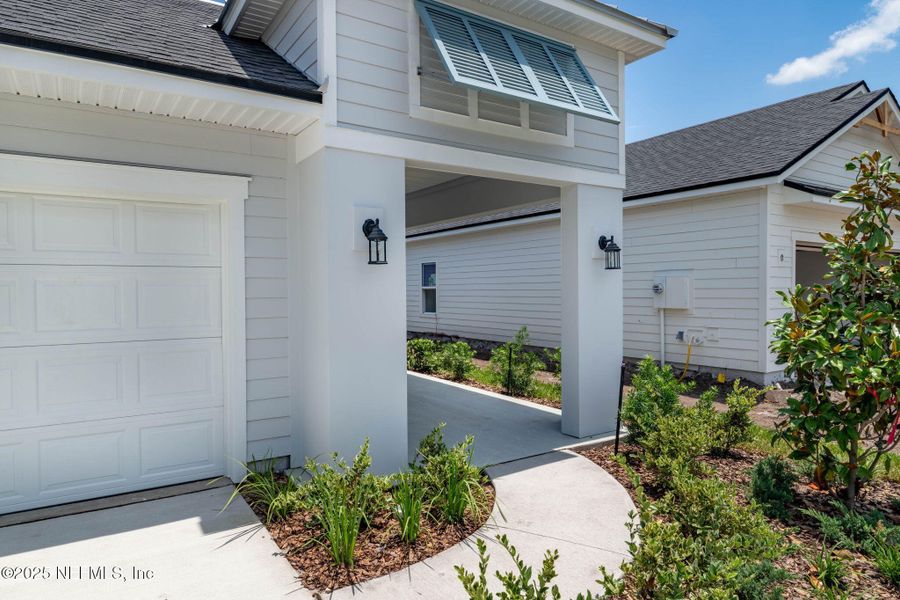 Front exterior of a new home in Beacon Lake, St. Augustine, FL, highlighting curb appeal (Image 27).