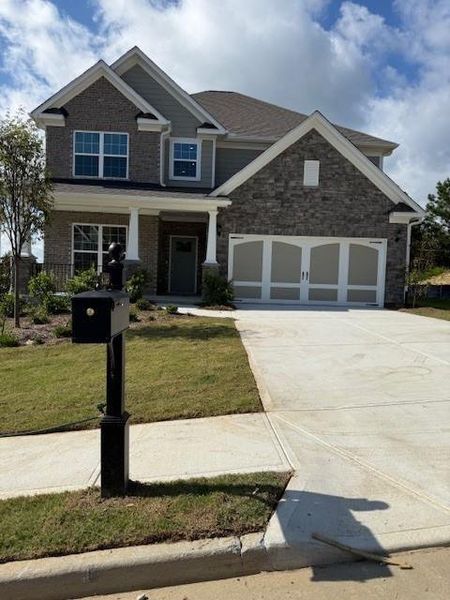 Front exterior of a new home in Sierra Creek, Hoschton, GA, highlighting curb appeal (Image 2).