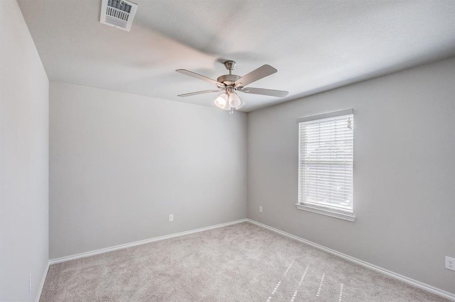 Spare room featuring carpet and ceiling fan Spare room featuring carpet and ceiling fan