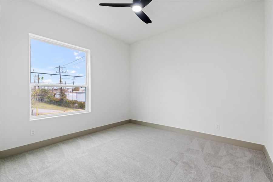 Whether you’re taking meetings or finding a moment of focus, this light-filled flex space offers the perfect setup for a home office, reading nook, or creative retreat—complete with plush carpet, modern trim, and serene window views.