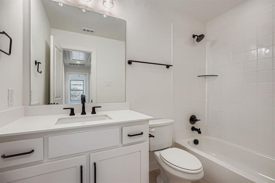 Bathroom featuring bathing tub / shower combination and vanity Bathroom featuring bathing tub / shower combination and vanity