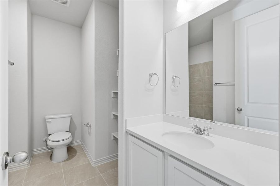 Bathroom featuring light tile patterned floors and vanity Bathroom featuring light tile patterned floors and vanity