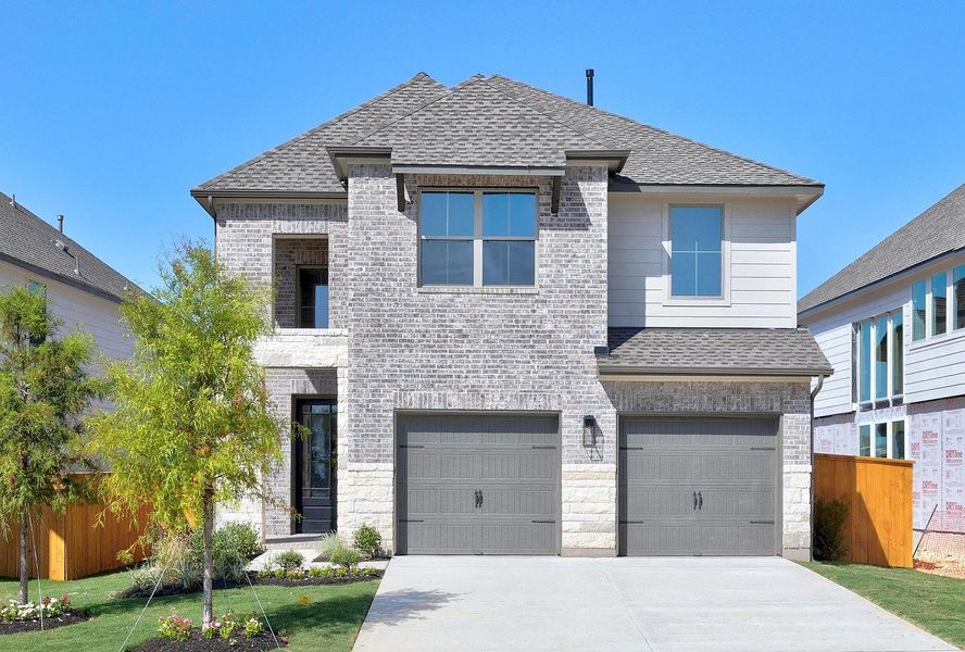 Front exterior of a new home in Parmer Ranch, Georgetown, TX, highlighting curb appeal (Image 2). Front exterior of a new home in Parmer Ranch, Georgetown, TX, highlighting curb appeal (Image 2).