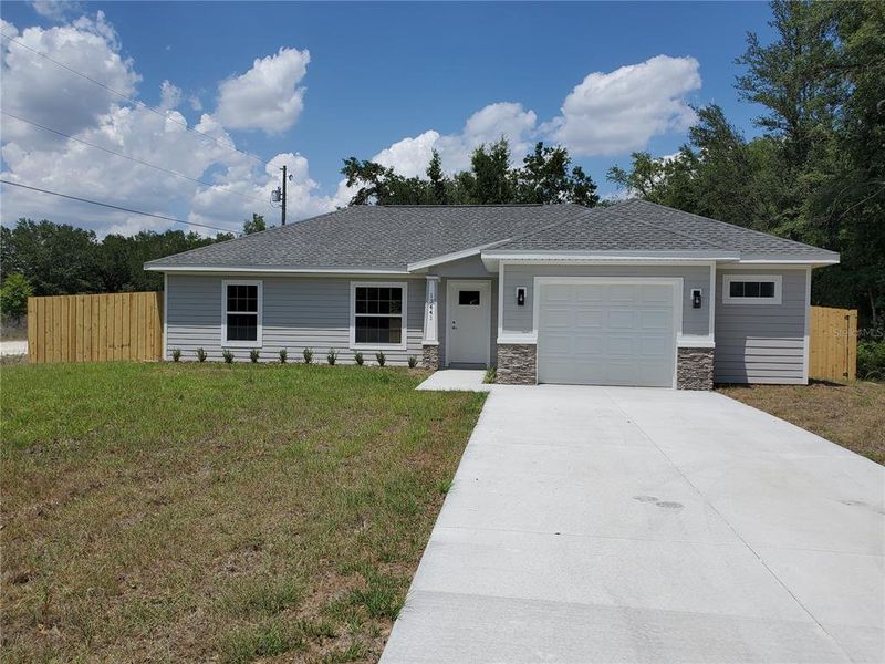 Front exterior of a new home in , Dunnellon, FL, highlighting curb appeal (Image 29).