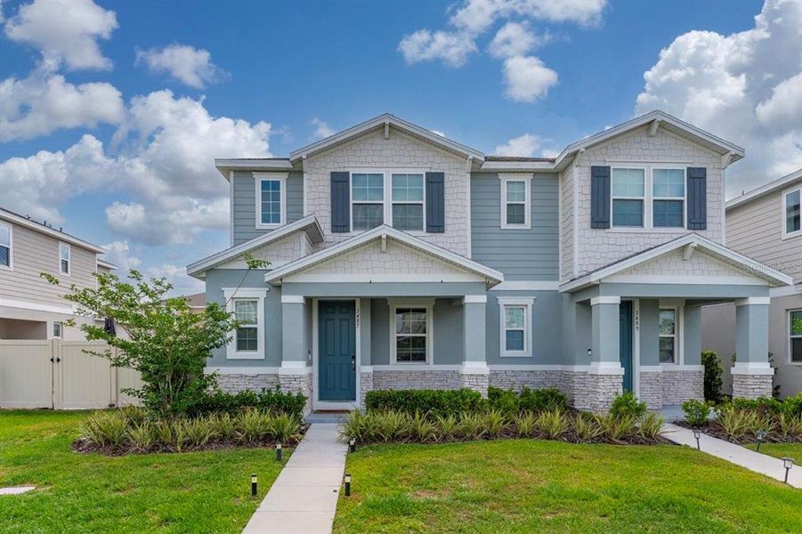 Front exterior of a new home in Urban Collection at Big Sky, Kissimmee, FL, highlighting curb appeal (Image 22).