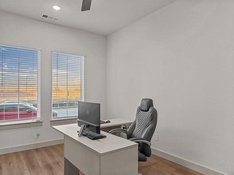 Office area with ceiling fan and light wood-type flooring