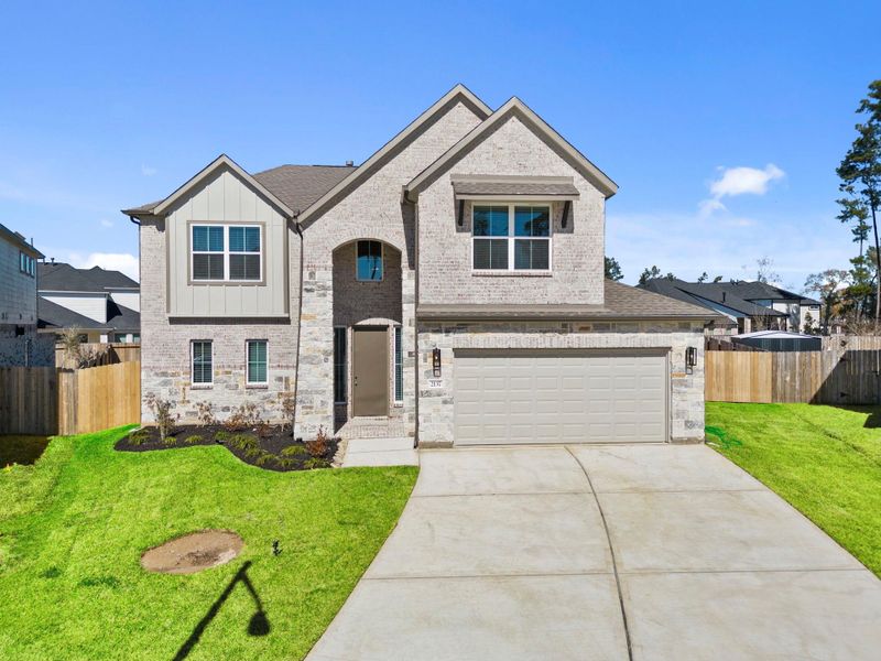 Front exterior of a new home in Barton Creek Ranch, Conroe, TX, highlighting curb appeal (Image 22). Front exterior of a new home in Barton Creek Ranch, Conroe, TX, highlighting curb appeal (Image 22).