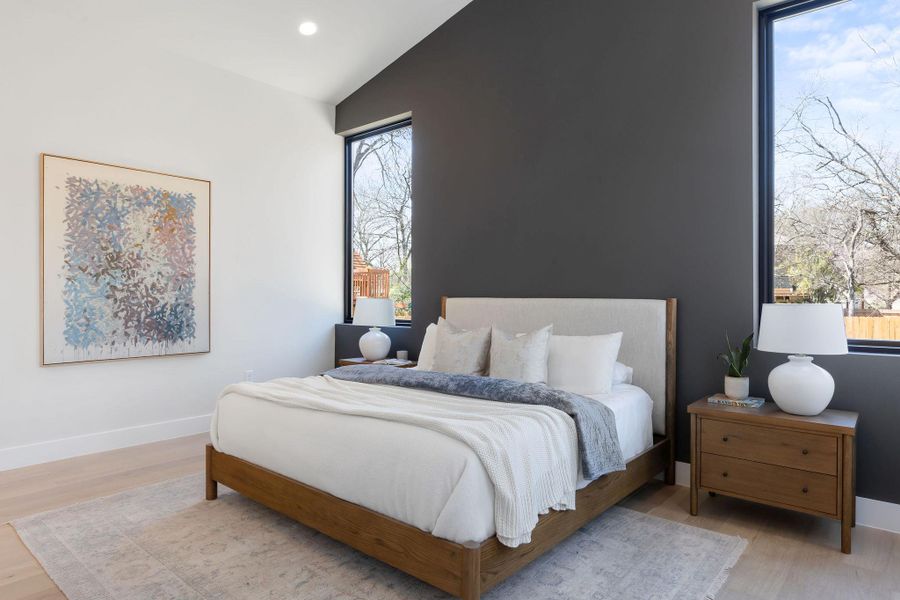 Bedroom featuring recessed lighting, baseboards, lofted ceiling, and wood finished floors