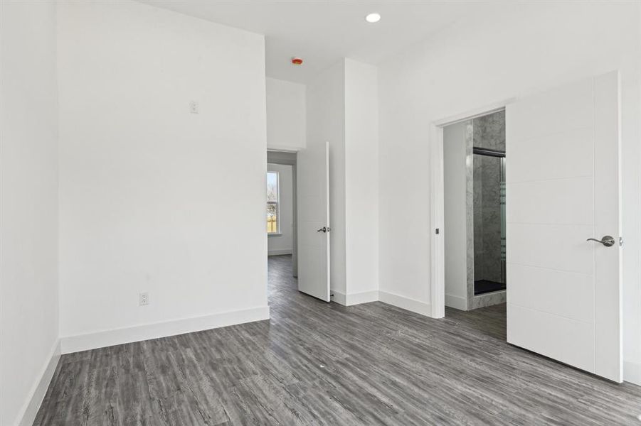 Unfurnished bedroom featuring baseboards, wood finished floors, and recessed lighting