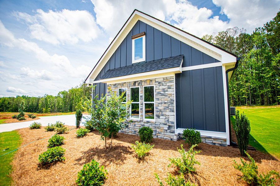 Front exterior of a new home in WOODMONT RESERVE, Roopville, GA, highlighting curb appeal (Image 36).