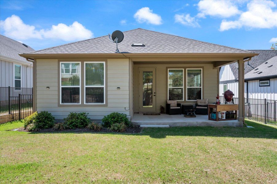 Back of house featuring a patio area, a shingled roof, and outdoor lounge area Back of house featuring a patio area, a shingled roof, and outdoor lounge area